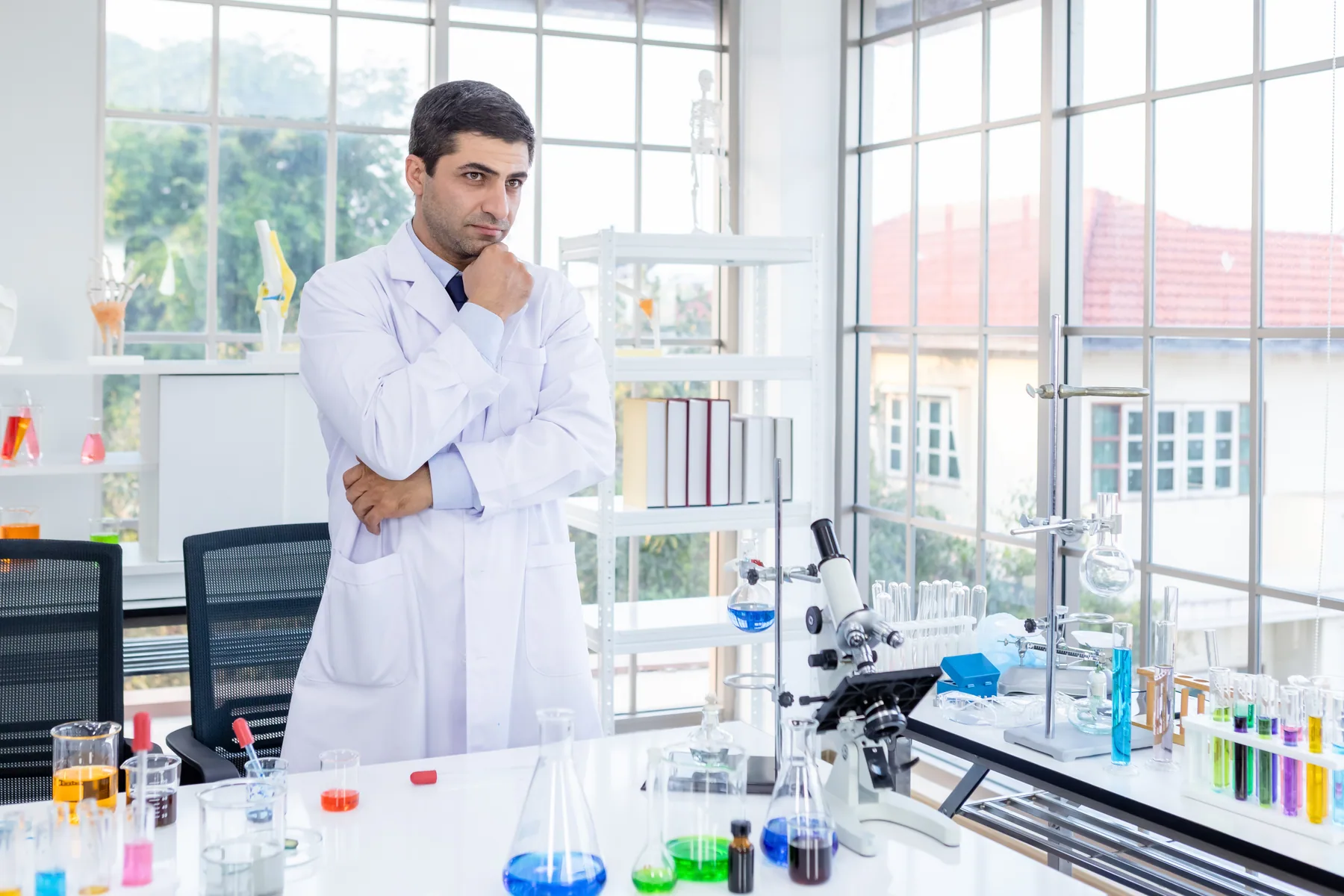 A scientist holding a sample tube in a laboratory.